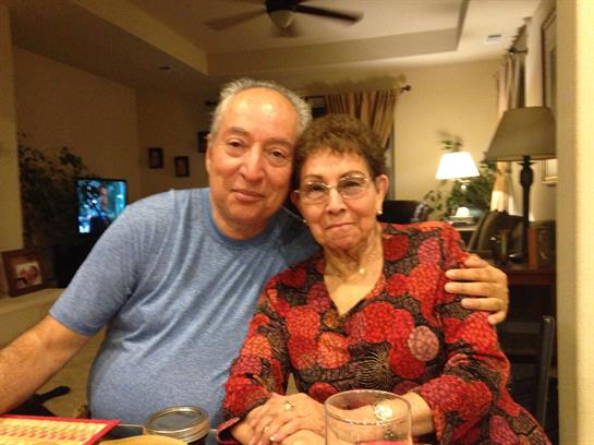 Elderly couple joyfully sharing a warm moment in their cozy living room.