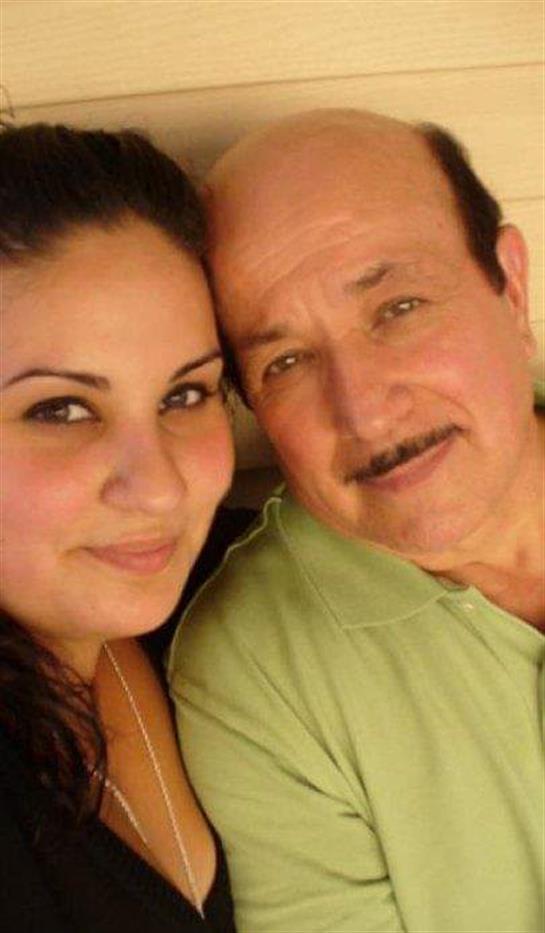 A man and woman smile warmly at the camera, showcasing a moment of affection and happiness.