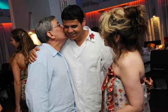 Two family members share a loving moment while celebrating joyfully during a festive gathering.