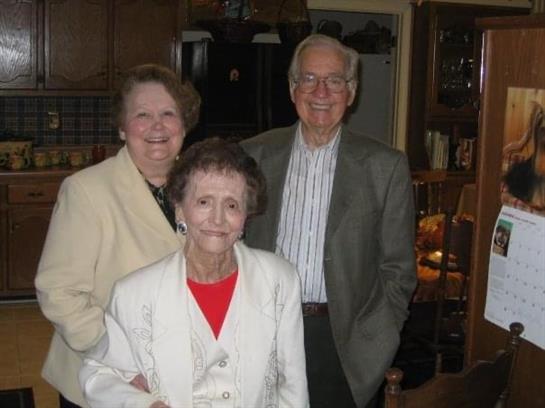 Family members gather together in a lively atmosphere, sharing smiles and joy in a comfortable home.