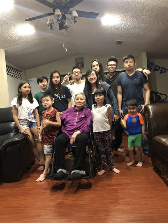 Family members of all ages gather together in a cozy living room, sharing joyful moments.