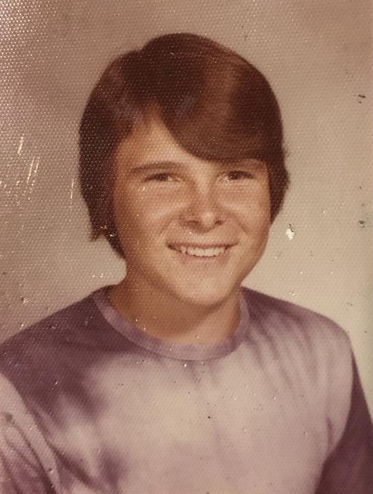 A smiling boy in a tie-dye shirt embodies the innocence of childhood.