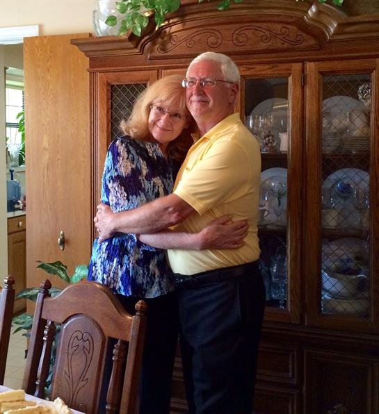 A warm moment shared between two people in a dining room filled with family warmth.