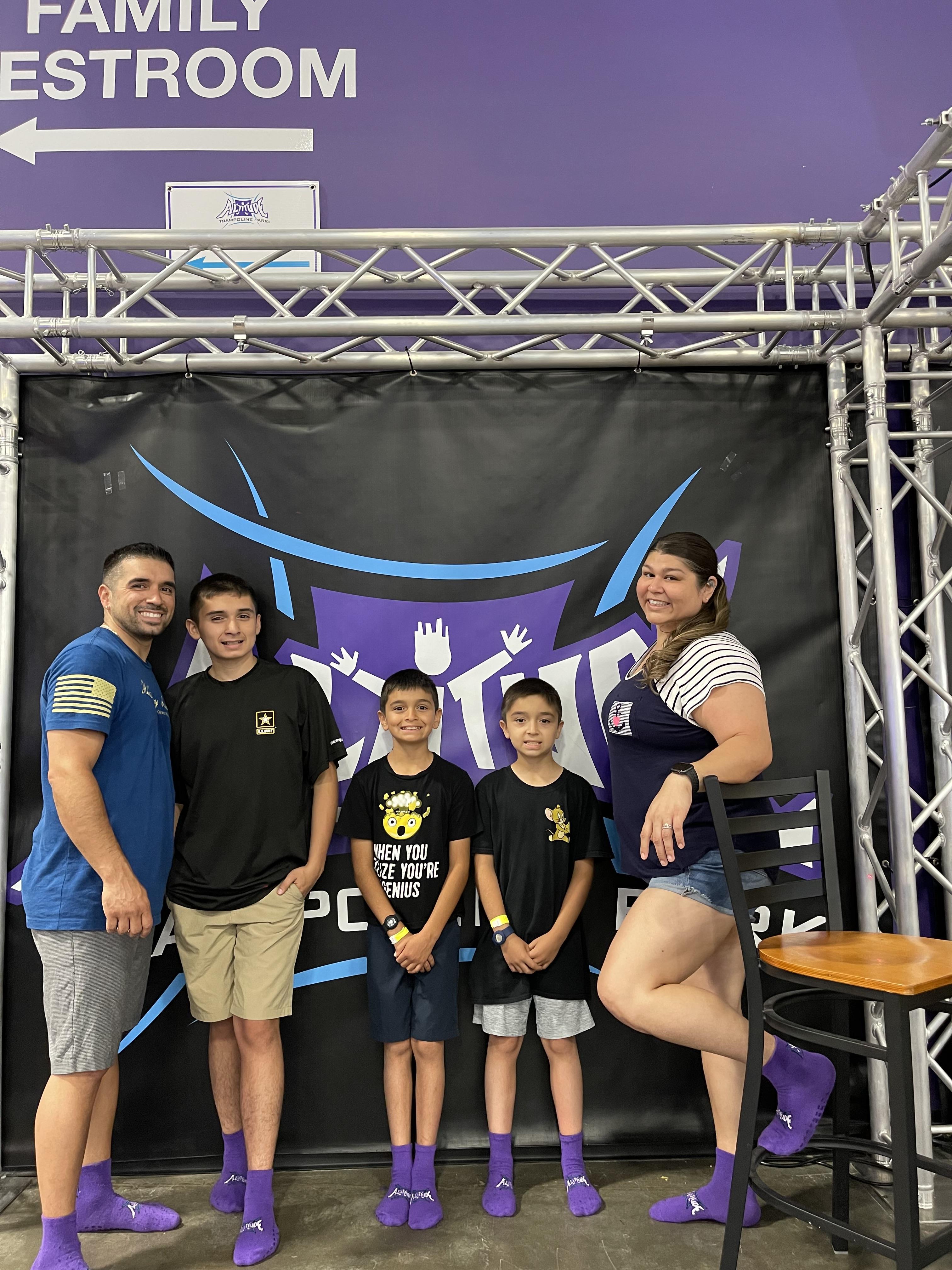 Group of five enjoying their time at a trampoline park, showcasing colorful socks and excitement.