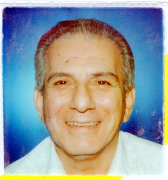 An elderly man smiles warmly against a vibrant blue backdrop, exuding happiness and warmth.