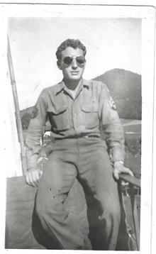 Soldier enjoys some downtime outside with a relaxed demeanor and cool sunglasses.