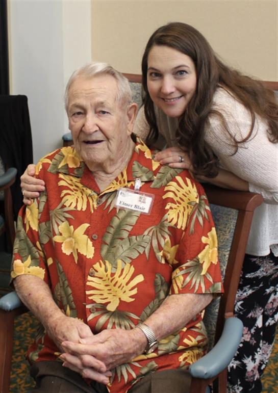 Caregiver and elderly man share a joyful moment during a visit at the retirement community.