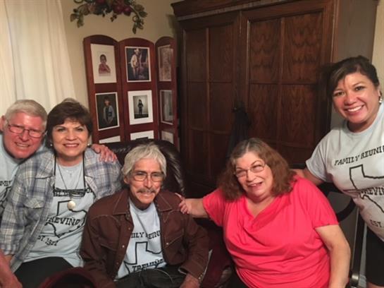 Four friends share laughter and memories in a cozy living room.