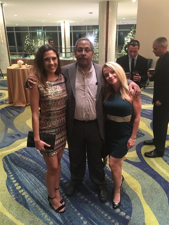 People gather at a hotel for a joyous celebration with drinks and engaging conversation.