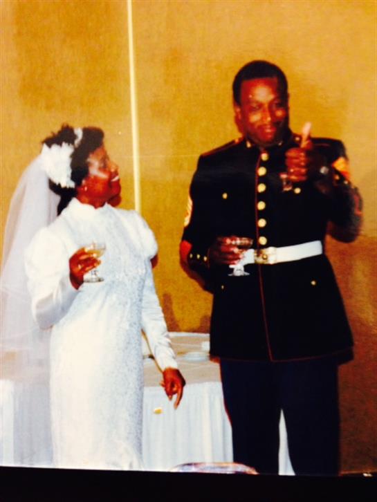 A happy couple toasts drinks together at their joyful wedding celebration.