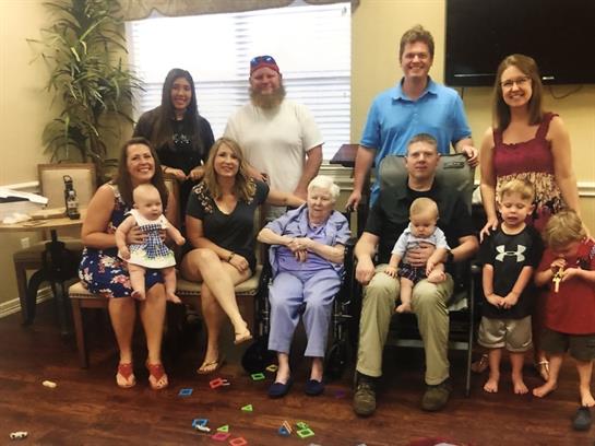 A happy family gathers in the living room, celebrating togetherness in the afternoon sun.