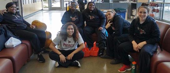 A group of friends poses together, showing camaraderie and joy in a communal space.
