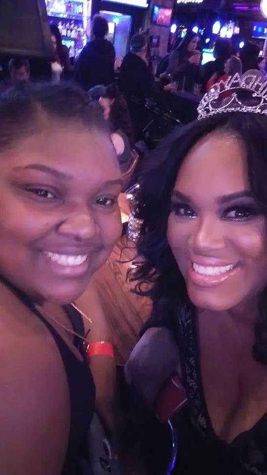 Two women with warm smiles enjoy a joyful moment during a celebratory event, radiating happiness.