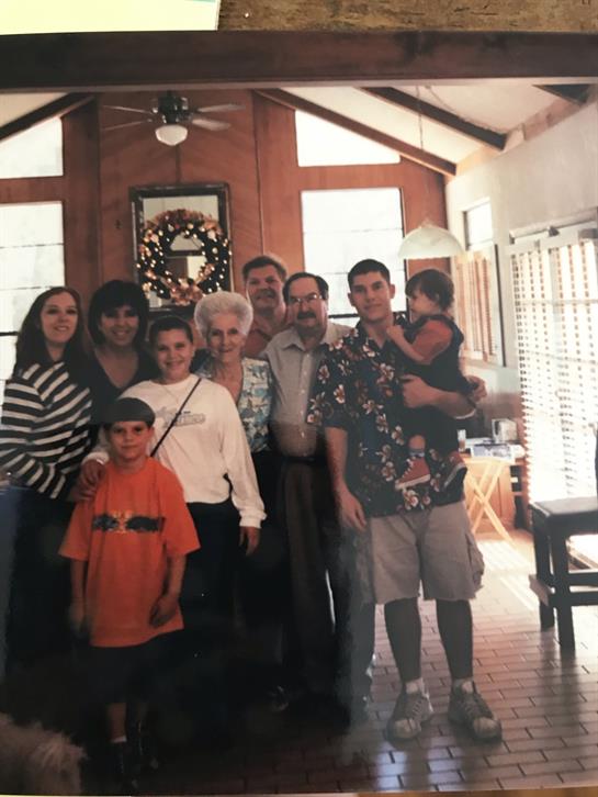 Friends and family gather in a bright living room to celebrate together, showcasing joy and unity.