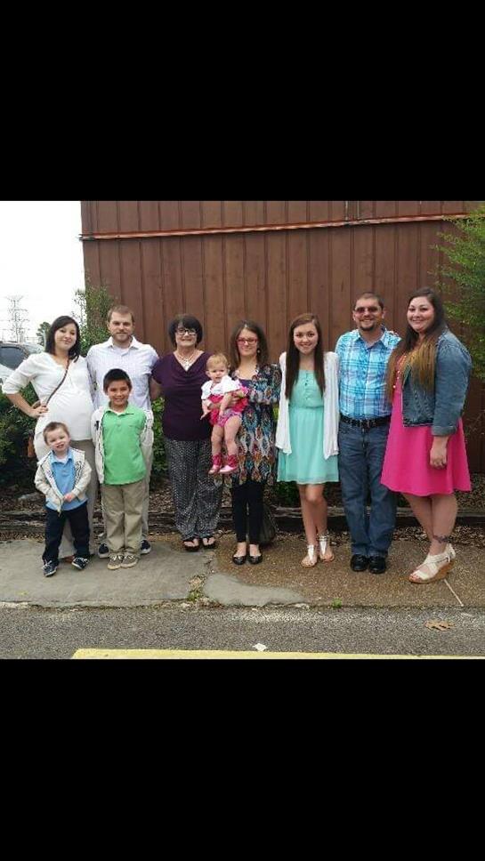Family members gather outdoors, smiling and enjoying spring together.