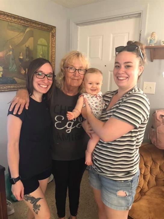 Generations of family come together in a warm home, sharing joy and smiles in a loving atmosphere.