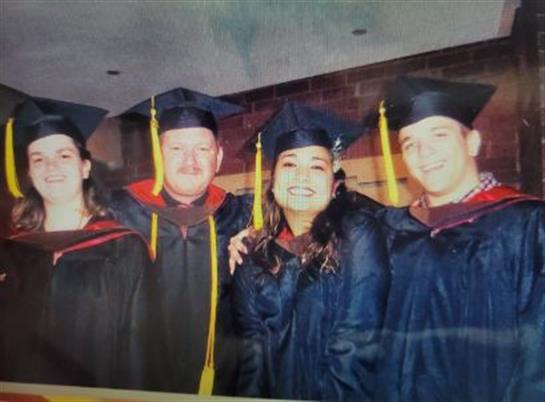 Friends proudly pose together after their graduation ceremony, celebrating their academic success.