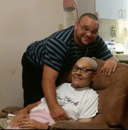 Grandfather and grandson share a joyful moment in a relaxed living room environment.