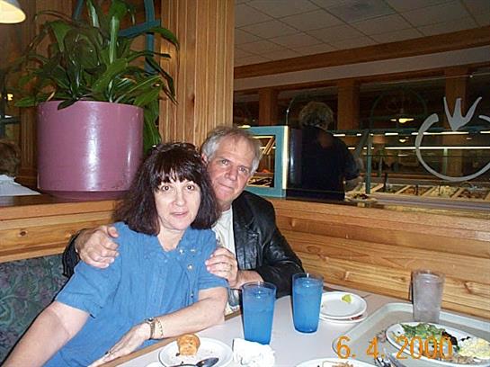 A couple shares a joyful moment over dinner in a warm, inviting restaurant ambiance.