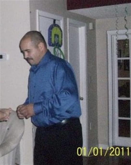 A man and woman engage in a lively conversation in a cozy indoor setting.