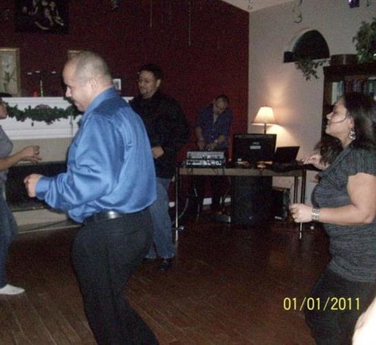 Couples dance joyfully indoors, music filling the air and creating a festive atmosphere.