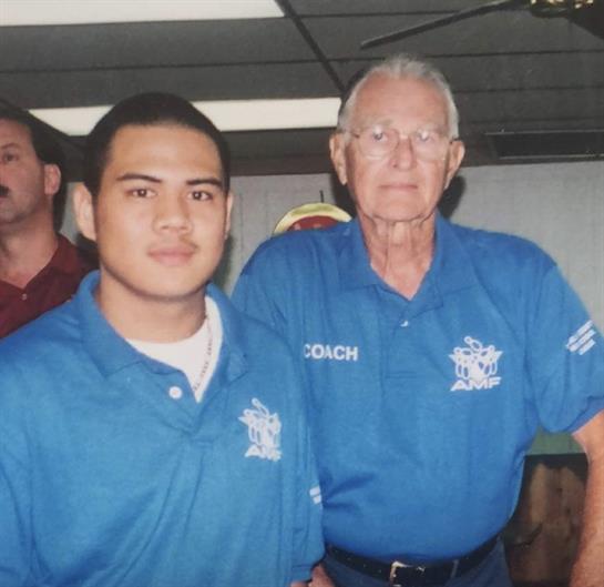 Two men pose at a community event, showcasing camaraderie and shared interests among attendees.