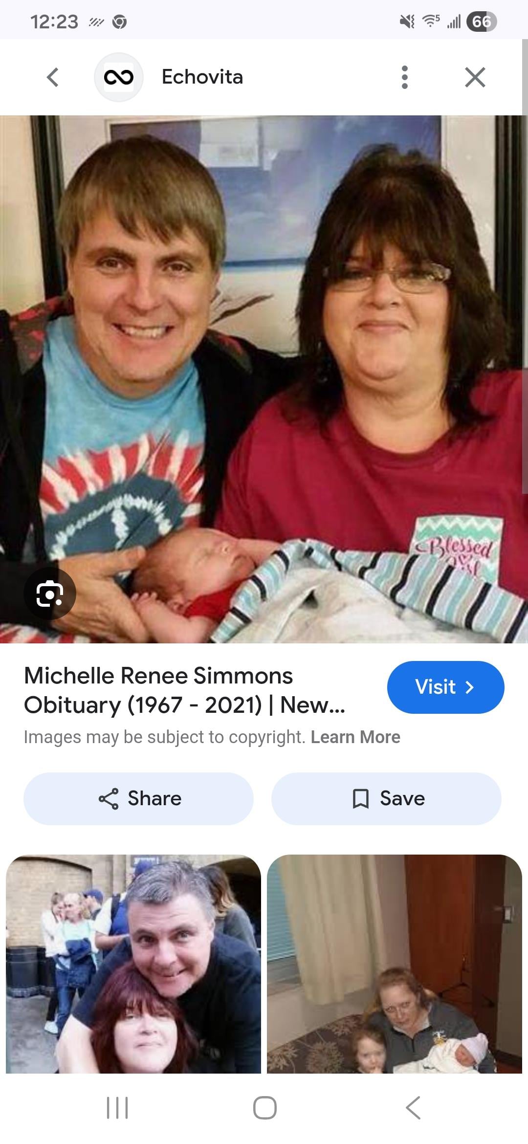 A man and woman holding a baby