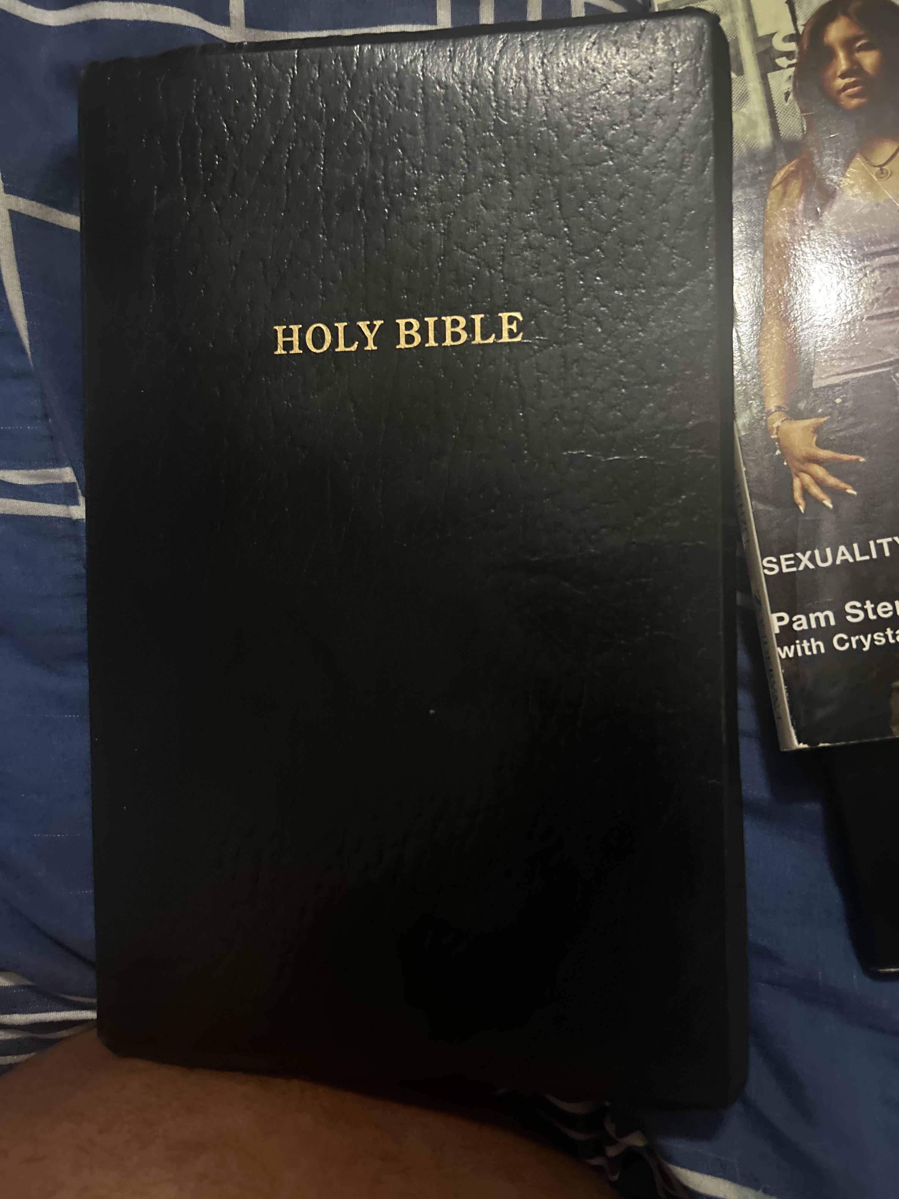 A black bible with gold text
