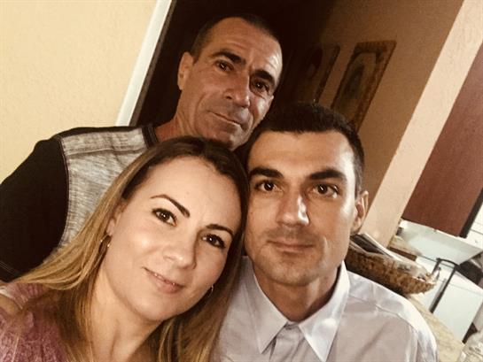 Friends enjoy each other's company, sharing smiles and laughter in a cozy indoor setting.