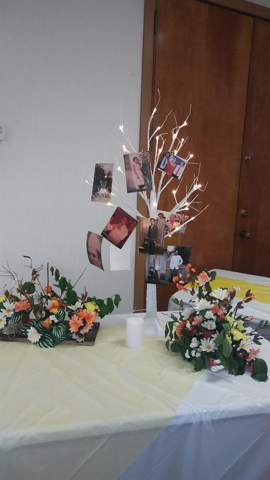 Floral decor and a photo display enhance the venue's festive atmosphere and highlight memories.