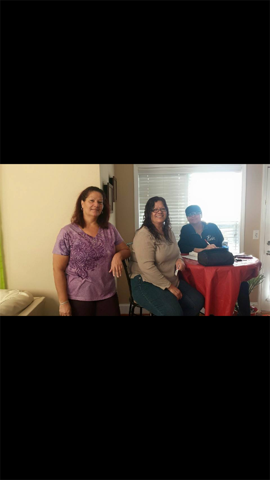 Three friends gather in a warm living room, engaging in conversation and relaxation together.