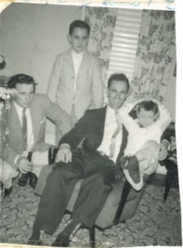 Four individuals relax in a living room, bonding and sharing laughter together.