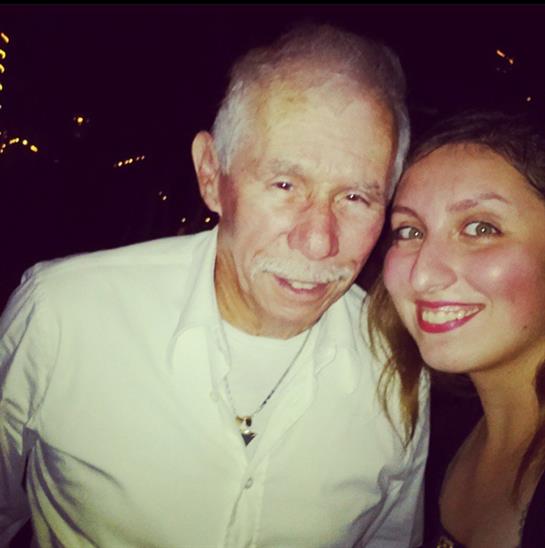 Two friends smile warmly, enjoying a festive evening filled with laughter and holiday cheer.