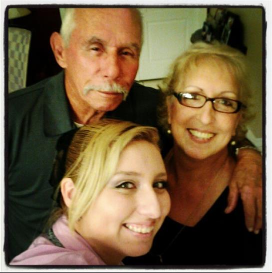 Three family members share joyful moments in a warm and inviting living space full of laughter.