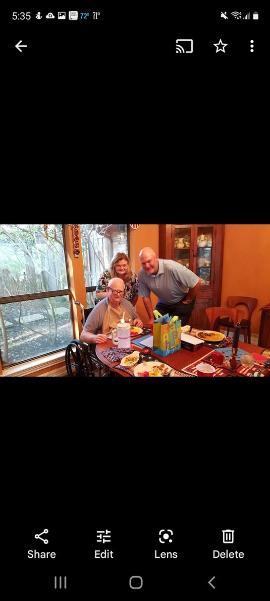 Three family members enjoy a meal together, laughing and sharing stories in a warm setting.