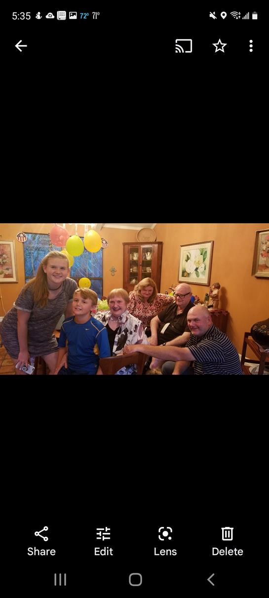 Friends and family gather in a warm, decorated room, celebrating together with laughter and joy.