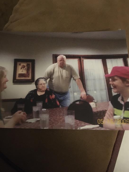 Friends gather around a table, sharing laughter and stories in a warm cafe atmosphere.