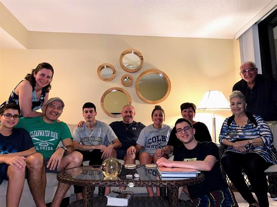 Friends and family enjoy quality time together in a cozy living room, sharing stories and laughter.