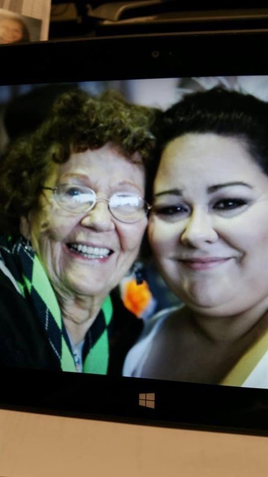 Two women are sharing a warm smile, enjoying their time together at a festive gathering.