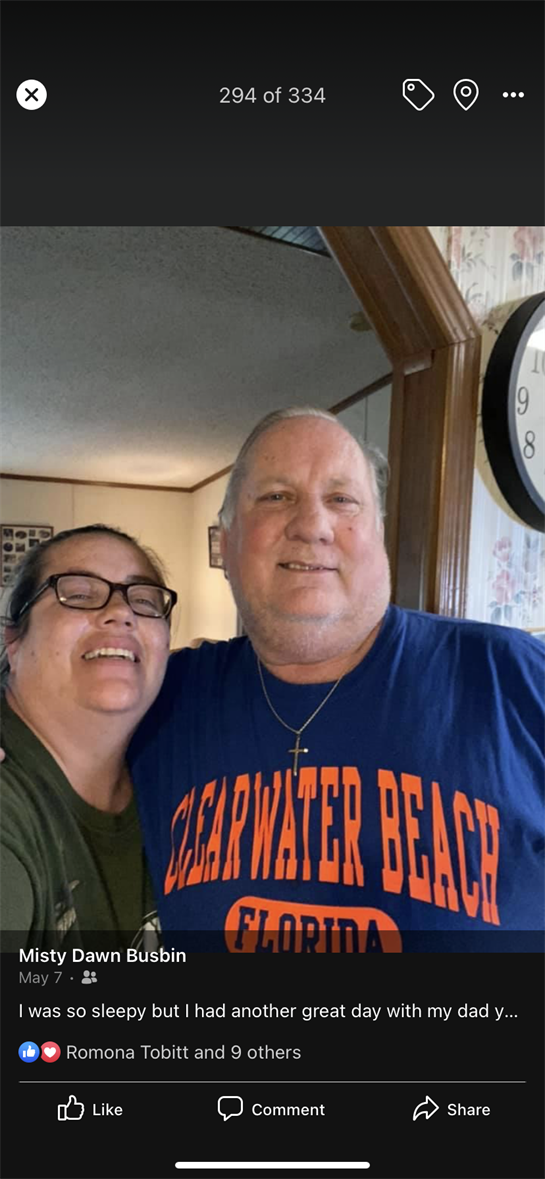 Two individuals share a joyful moment in a warm, inviting living room, smiling widely.