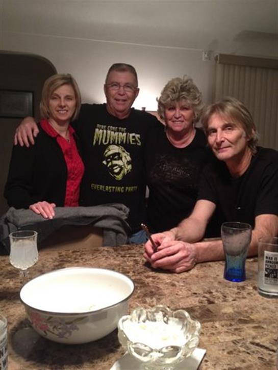 Four friends share laughter and conversation in a warm, inviting setting.