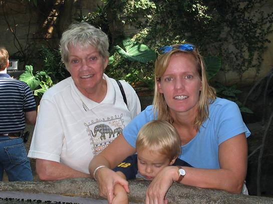 Three family members enjoy their time together at a nature park, creating lasting memories.
