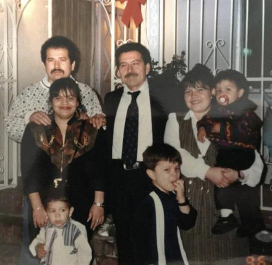 A joyful family reunion with adults and children celebrating together at home.