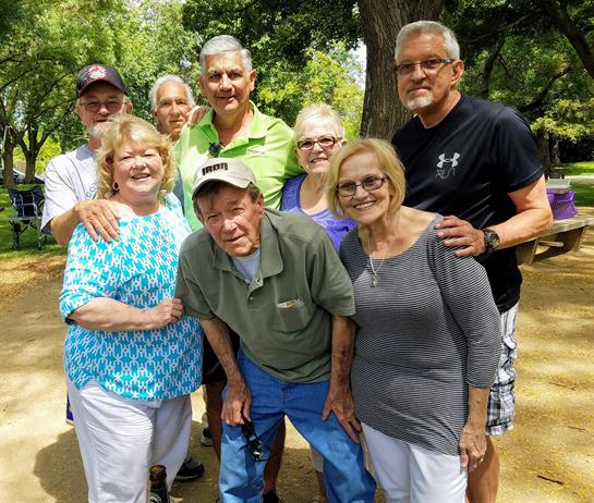 Friends and family enjoy a cheerful gathering in the park, sharing moments and smiles together.
