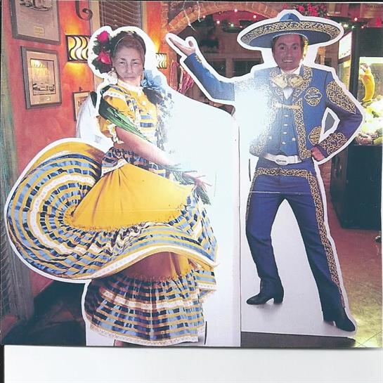 Two dancers in vibrant costumes showcase traditional dances, embodying cultural heritage.