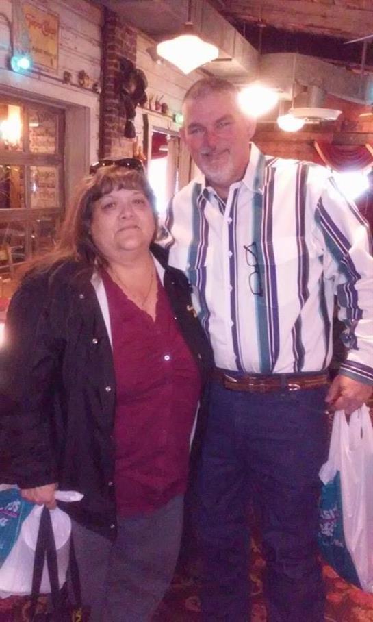 Friends pose happily together in a restaurant setting filled with lively decor and ambiance.