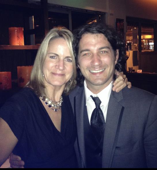 A couple enjoys their time at an elegant evening gathering, showcasing joyful expressions.