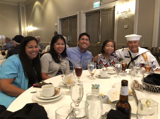 Friends and family enjoy a meal together at a banquet hall for a joyful celebration.