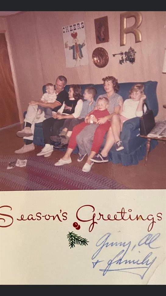 A joyful family is enjoying a cozy moment together on a sofa in a decorated living room.