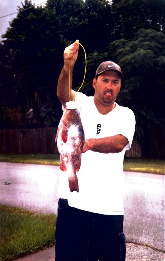 Fisherman shows off his impressive catch after a successful day at the lake enjoying the summer sun.